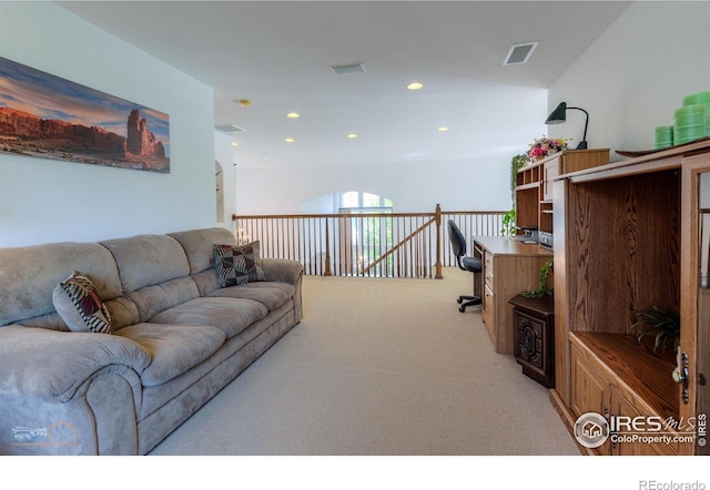 living area with recessed lighting, visible vents, and light colored carpet