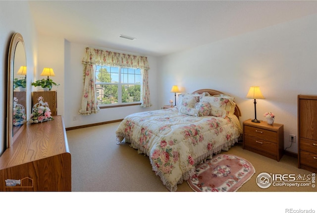 bedroom with light carpet, baseboards, and visible vents