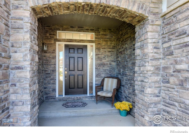 view of exterior entry featuring stone siding