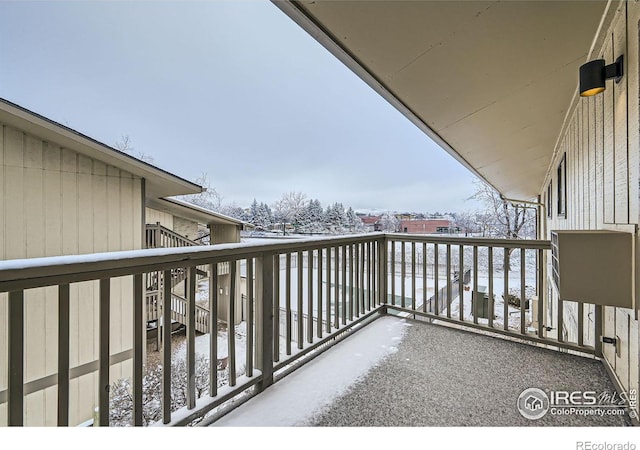 view of snow covered back of property