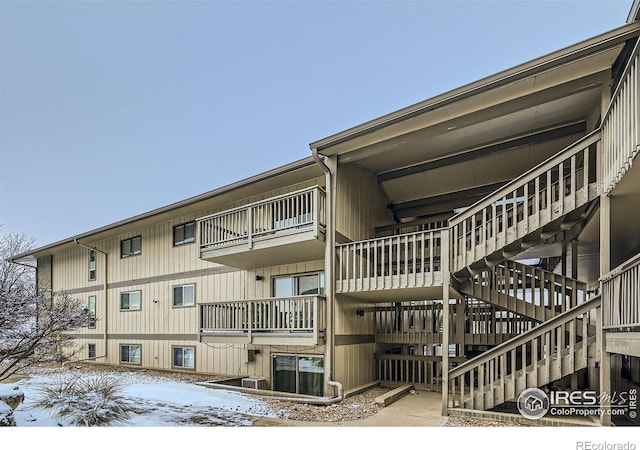 snow covered building featuring stairway