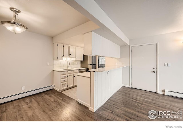 kitchen featuring white cabinets, light countertops, and a sink