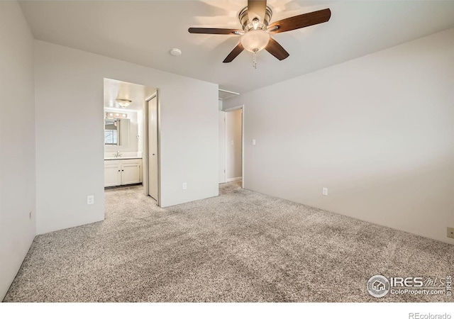 unfurnished bedroom with light carpet, ceiling fan, and ensuite bathroom