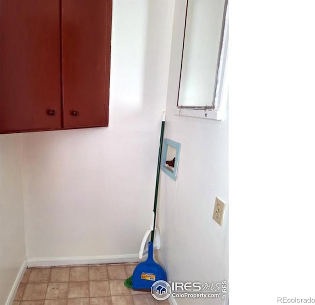 laundry area featuring hookup for a washing machine, cabinet space, and baseboards