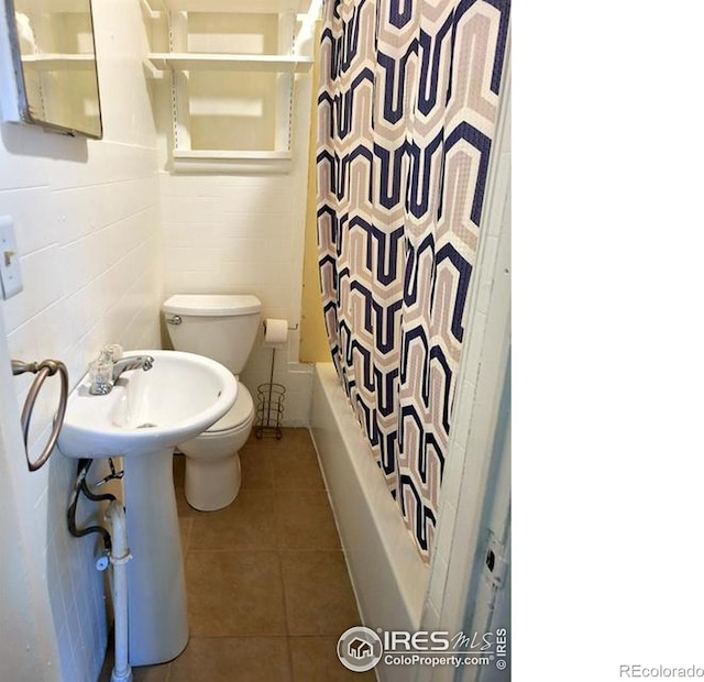 full bath with shower / bath combination with curtain, toilet, and tile patterned floors