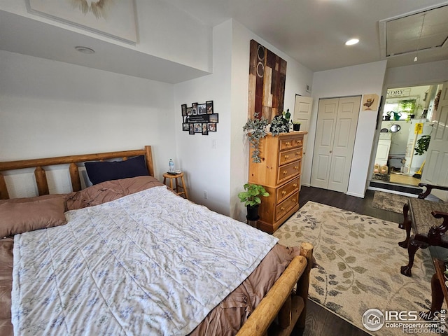 bedroom with dark wood finished floors, attic access, and recessed lighting