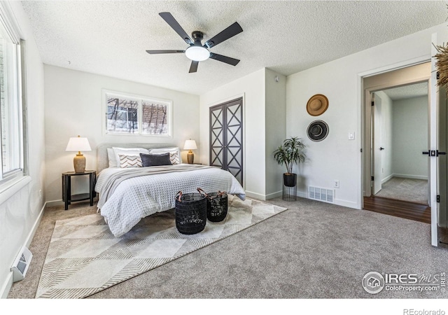 bedroom featuring multiple windows, visible vents, and light colored carpet