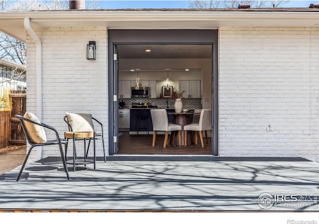 entrance to property featuring brick siding