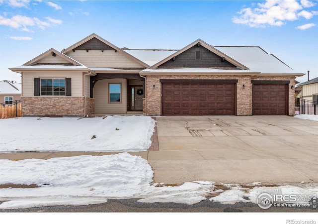 view of front of home with a garage, concrete driveway, and fence