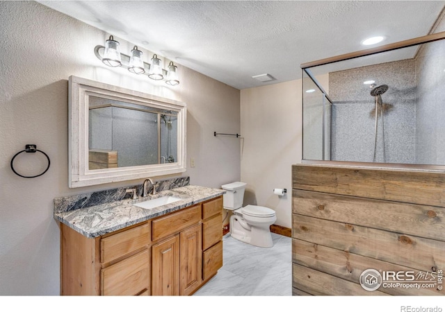 bathroom with a shower, visible vents, toilet, a textured ceiling, and vanity