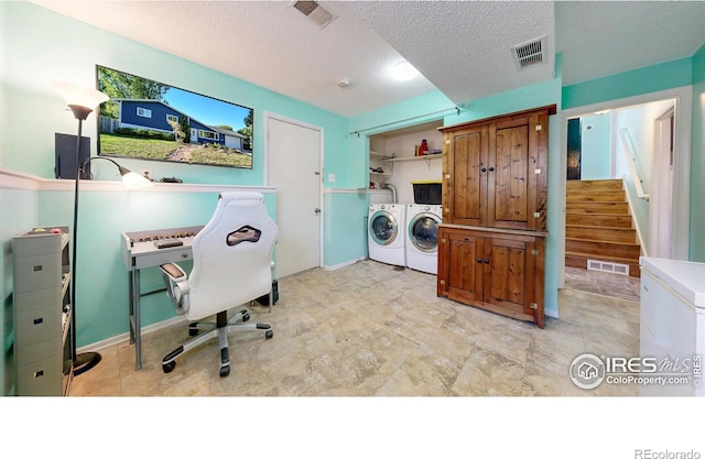 washroom with laundry area, visible vents, and washing machine and clothes dryer