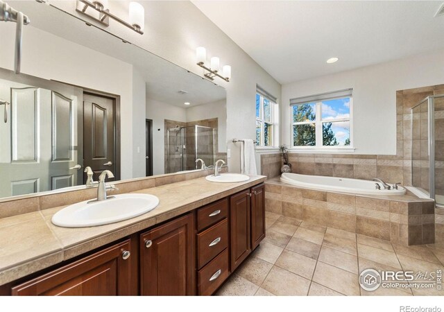 full bath featuring double vanity, a shower stall, and a sink