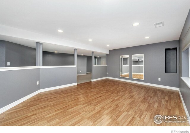 unfurnished living room with baseboards, recessed lighting, visible vents, and light wood-style floors