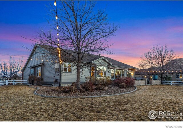 view of front of home with fence and a front yard