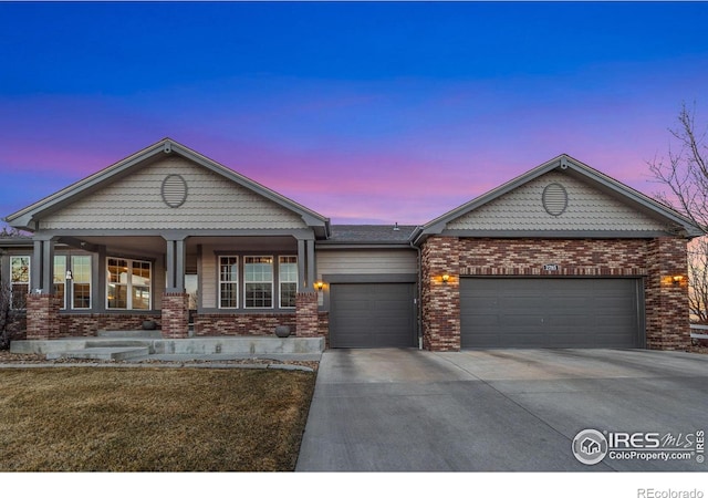 view of front of house with concrete driveway, brick siding, and an attached garage