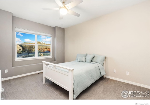 bedroom with ceiling fan, baseboards, and light colored carpet