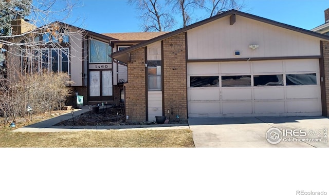 view of front of house with a garage, driveway, and brick siding