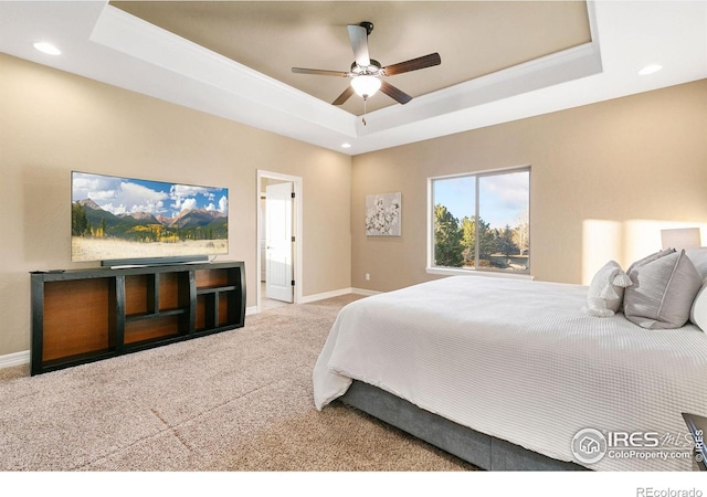 carpeted bedroom featuring a tray ceiling, ceiling fan, baseboards, and recessed lighting