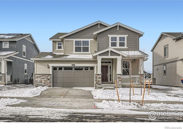 craftsman house with stone siding, concrete driveway, and an attached garage