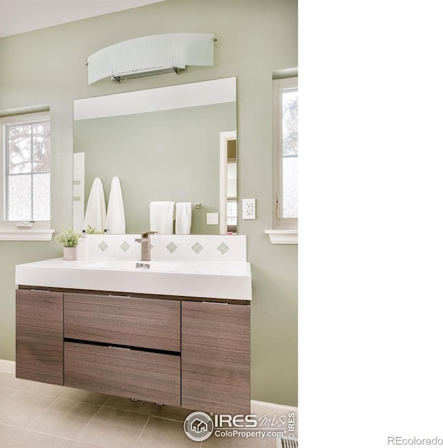 1516 Columbine Ave, Boulder, CO 80302 - bathroom with vanity, baseboards, a healthy amount of sunlight, and tile patterned flooring