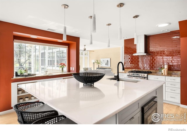 1516 Columbine Ave, Boulder, CO 80302 - kitchen featuring wall chimney exhaust hood, a sink, visible vents, backsplash, and gas stove