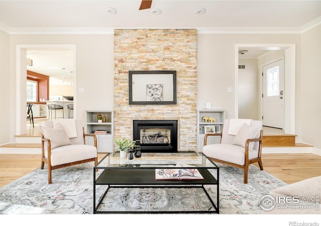 1516 Columbine Ave, Boulder, CO 80302 - living room featuring wood finished floors, crown molding, baseboards, and a stone fireplace