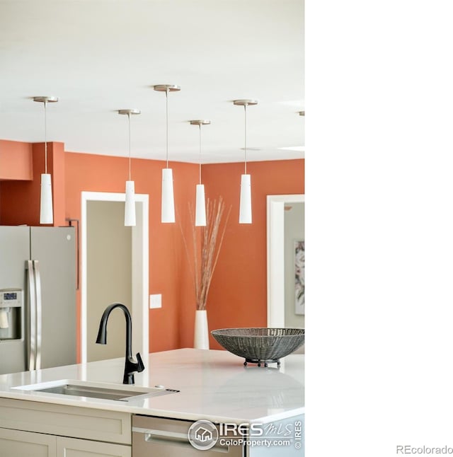 1516 Columbine Ave, Boulder, CO 80302 - kitchen featuring light countertops, hanging light fixtures, stainless steel appliances, and a sink