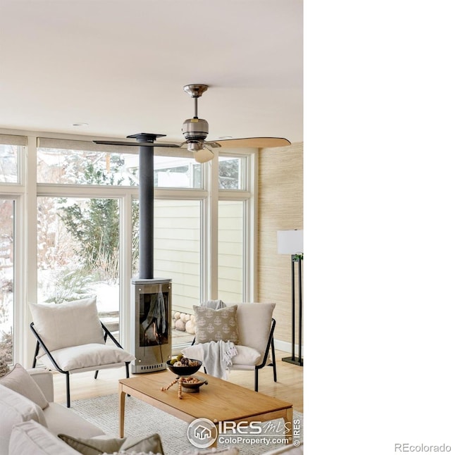 1516 Columbine Ave, Boulder, CO 80302 - living area with ceiling fan, light wood-style flooring, and a wood stove