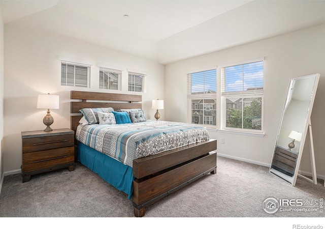 bedroom featuring light carpet and baseboards