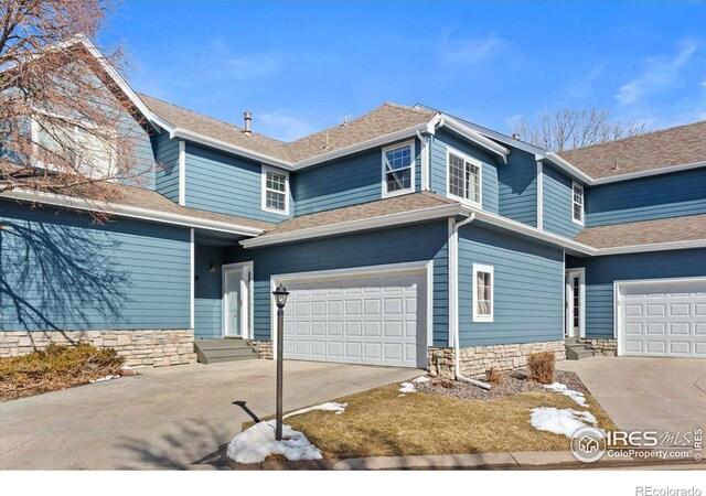 view of front of house featuring entry steps, an attached garage, a shingled roof, and concrete driveway