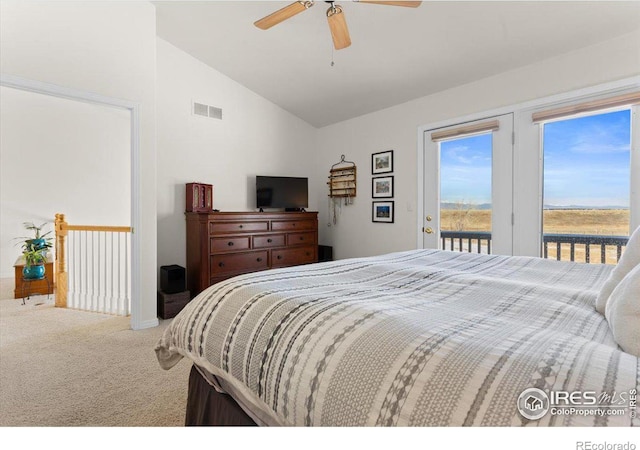 carpeted bedroom featuring access to exterior, ceiling fan, visible vents, and vaulted ceiling