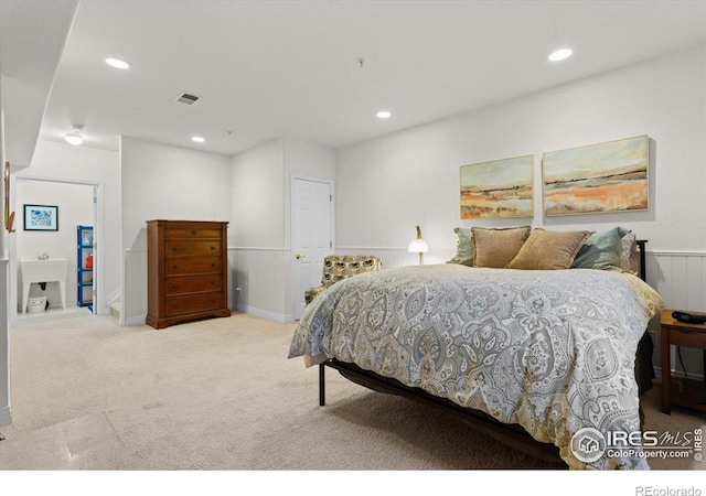 bedroom with light carpet, visible vents, and recessed lighting