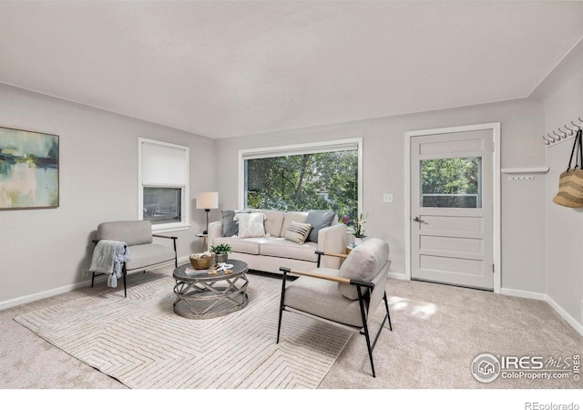 living room with light carpet and baseboards