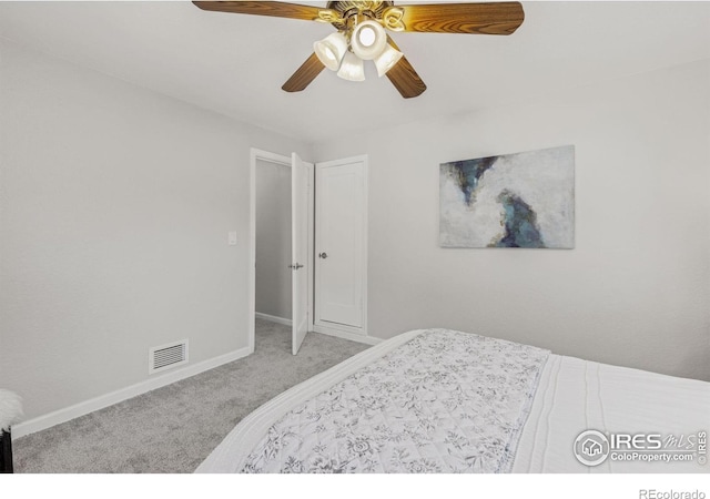 bedroom with visible vents, baseboards, a ceiling fan, and light colored carpet