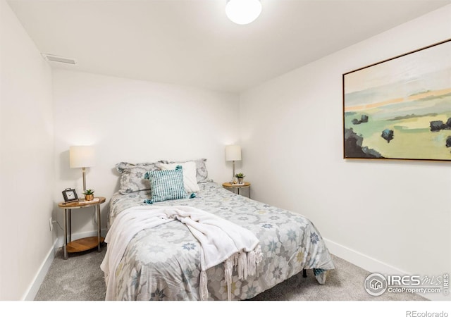 carpeted bedroom with baseboards