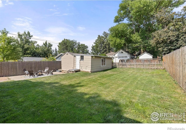 view of yard featuring an outbuilding, a patio, a storage shed, an outdoor fire pit, and a fenced backyard