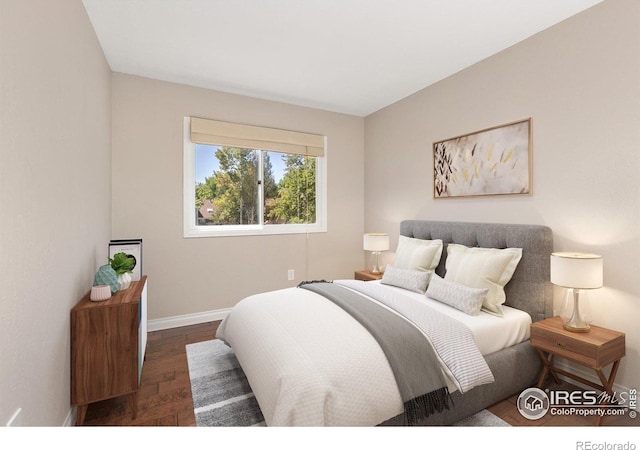 bedroom featuring dark wood-style floors and baseboards