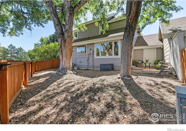 back of house featuring a patio and a fenced backyard