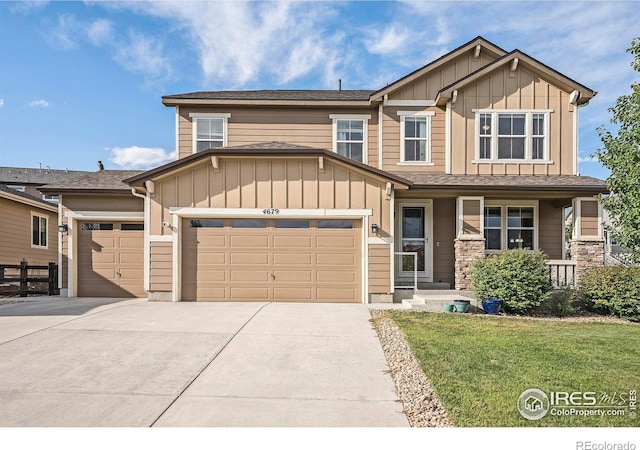 craftsman-style house with board and batten siding, a front yard, driveway, and a garage