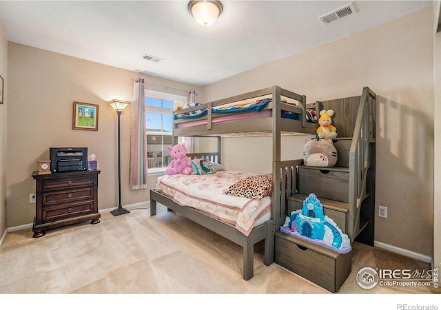 bedroom featuring baseboards, visible vents, and light colored carpet