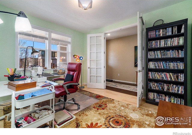 office with light wood-style flooring and baseboards