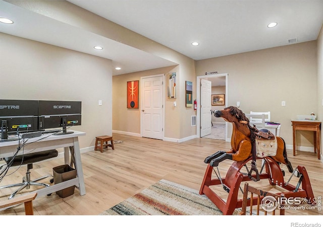 office space with light wood-type flooring, baseboards, visible vents, and recessed lighting