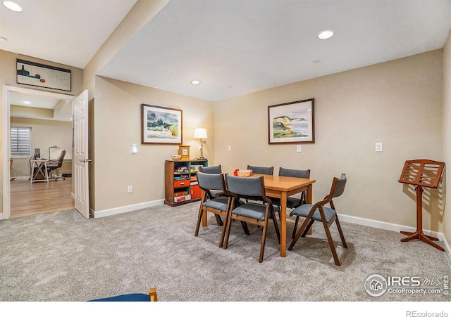 dining room with recessed lighting, baseboards, and light colored carpet