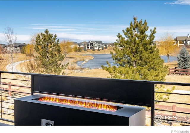 exterior space featuring a residential view and a fire pit