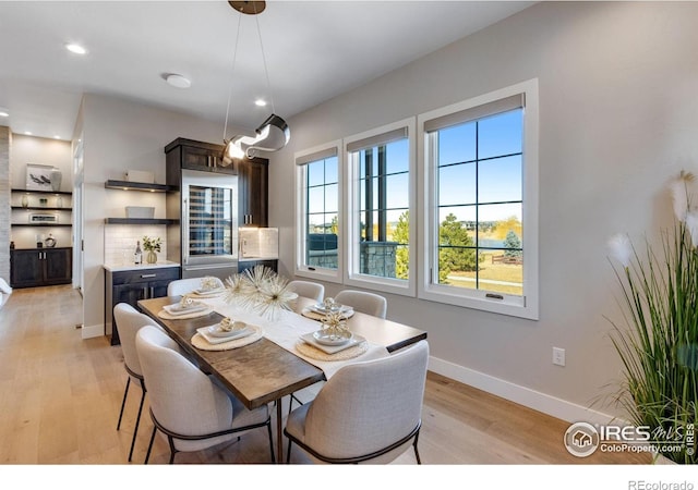 dining space with recessed lighting, light wood-style flooring, and baseboards