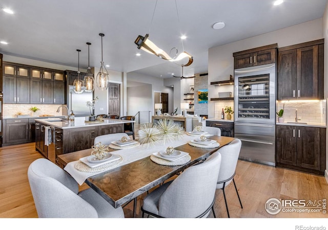 dining space featuring light wood-type flooring and recessed lighting