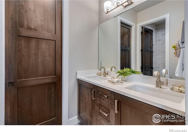 full bath with double vanity and a sink