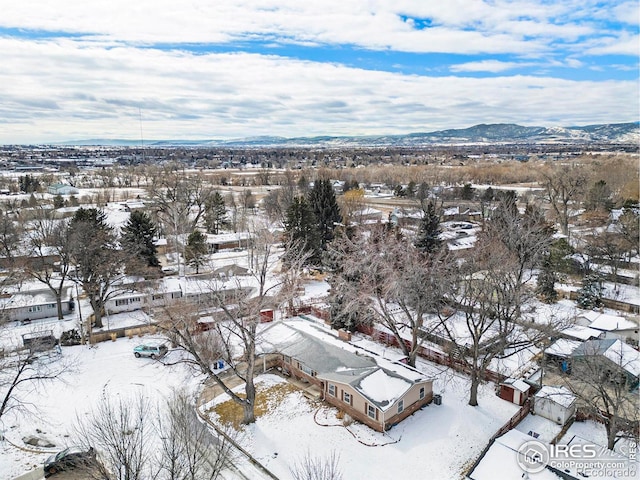 snowy aerial view with a mountain view