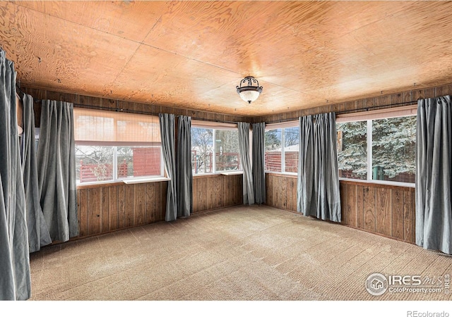 unfurnished sunroom featuring wooden ceiling