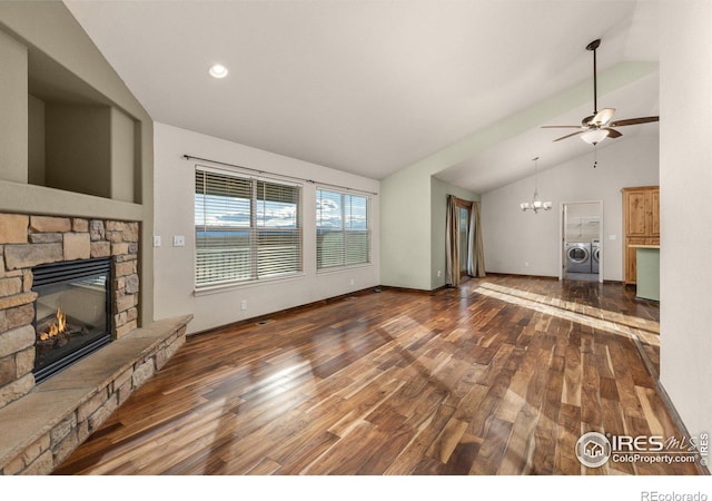 unfurnished living room with baseboards, dark wood-style flooring, washing machine and dryer, a fireplace, and ceiling fan with notable chandelier